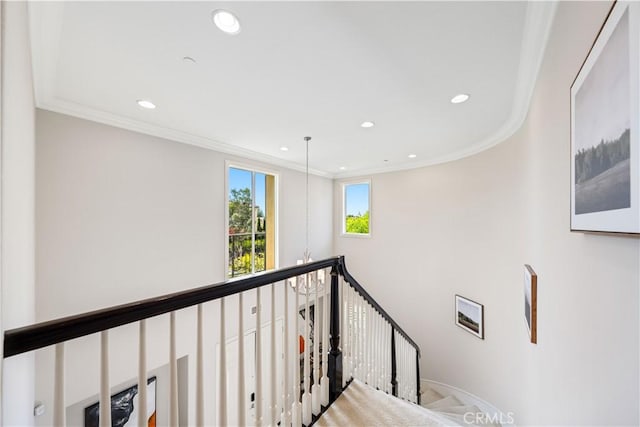 hallway featuring a chandelier and ornamental molding