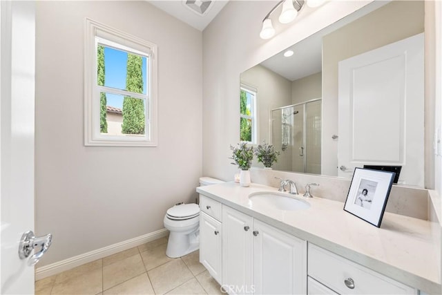 bathroom featuring tile patterned flooring, vanity, a shower with shower door, and a wealth of natural light