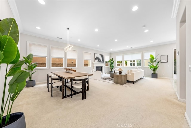 dining area with light carpet, an inviting chandelier, and crown molding