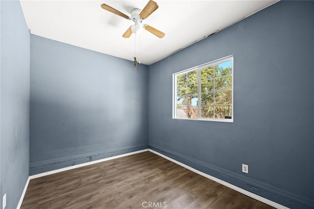 spare room featuring dark hardwood / wood-style flooring and ceiling fan