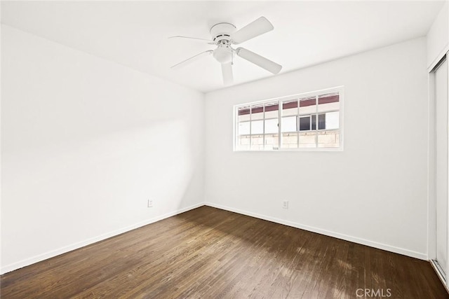 unfurnished room with dark hardwood / wood-style floors and ceiling fan