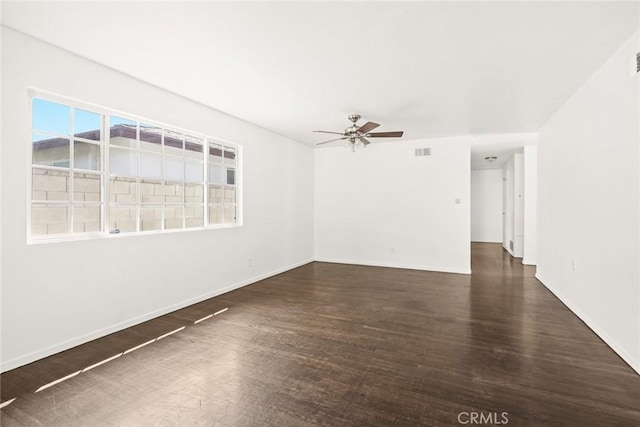 spare room with ceiling fan and dark wood-type flooring