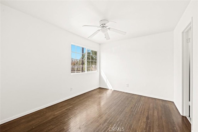 spare room featuring dark hardwood / wood-style floors and ceiling fan