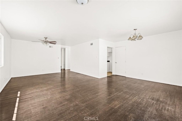 unfurnished living room featuring dark wood-type flooring and ceiling fan with notable chandelier