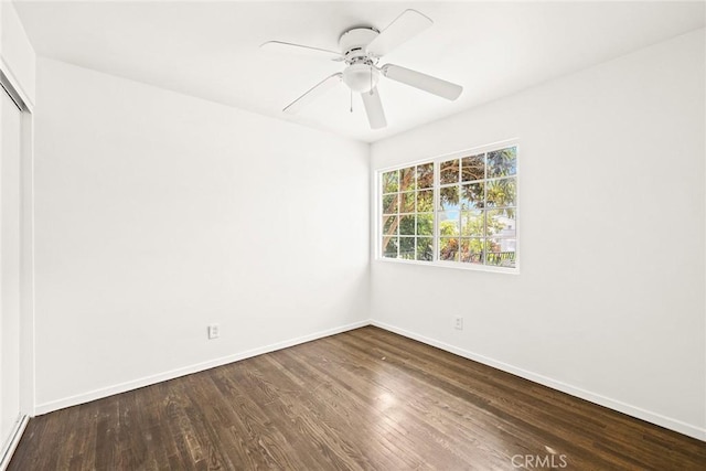 spare room with ceiling fan and dark hardwood / wood-style flooring