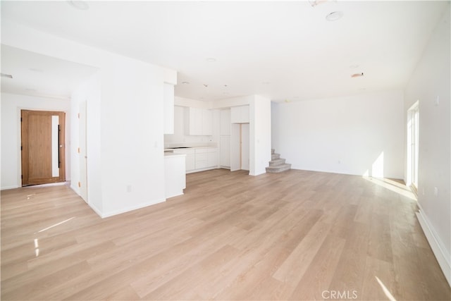 unfurnished living room featuring light hardwood / wood-style floors