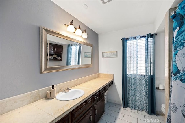 bathroom with tile patterned floors, vanity, and toilet