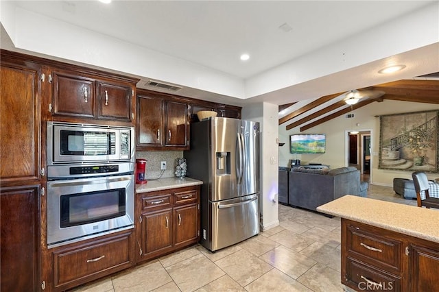 kitchen with dark brown cabinetry, ceiling fan, stainless steel appliances, tasteful backsplash, and vaulted ceiling with beams