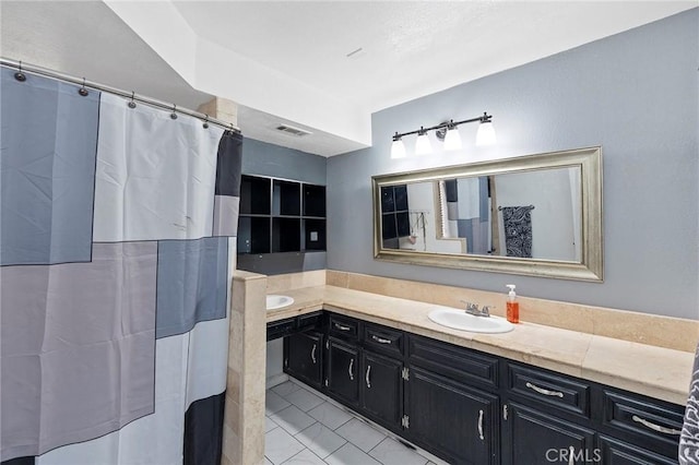 bathroom featuring tile patterned flooring and vanity