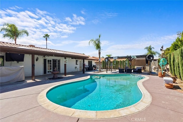 view of swimming pool featuring ceiling fan, a pergola, a patio, and french doors