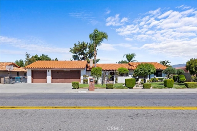 mediterranean / spanish-style house with a garage