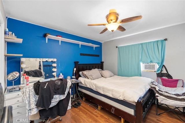 bedroom with ceiling fan and wood-type flooring