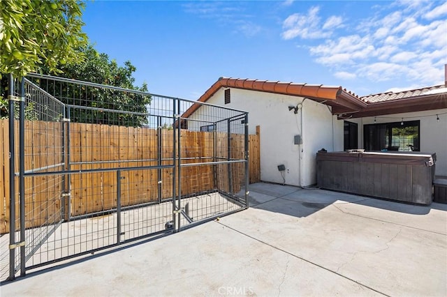 view of side of home with a hot tub