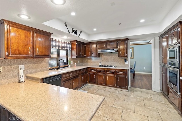 kitchen with tasteful backsplash, kitchen peninsula, sink, and appliances with stainless steel finishes