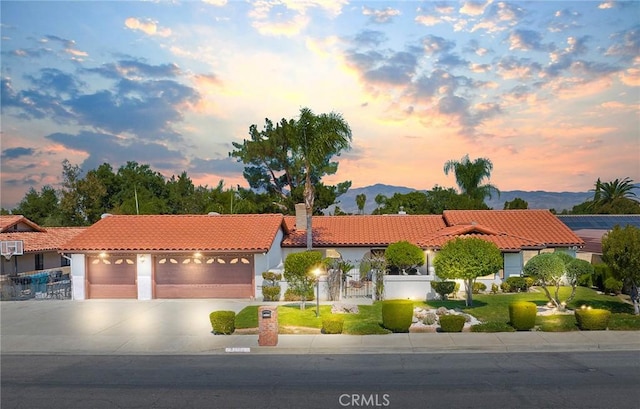 mediterranean / spanish home featuring a mountain view and a garage