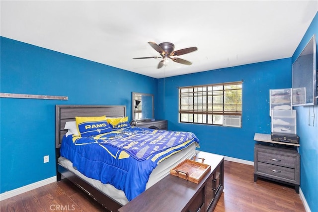 bedroom with dark hardwood / wood-style flooring, ceiling fan, and cooling unit