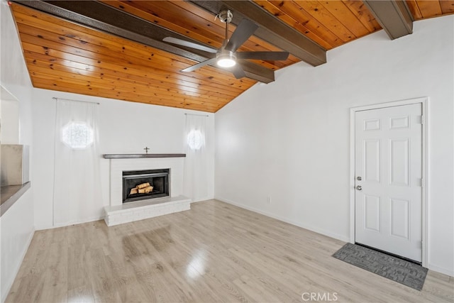 unfurnished living room featuring light hardwood / wood-style floors, wood ceiling, a brick fireplace, ceiling fan, and vaulted ceiling with beams