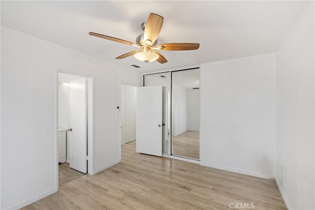 unfurnished bedroom featuring ceiling fan, light hardwood / wood-style flooring, and a closet