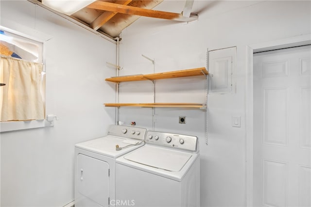 clothes washing area featuring electric panel and washer and dryer