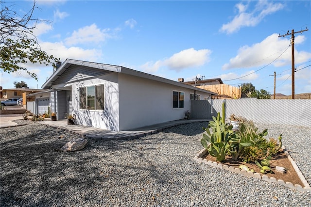 back of house featuring a garage