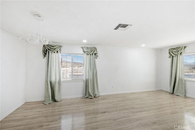 unfurnished room with light hardwood / wood-style flooring