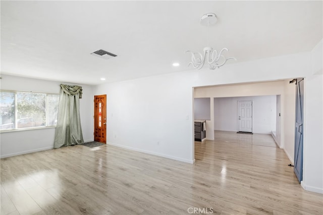 unfurnished room with light wood-type flooring