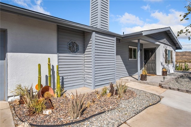 doorway to property with a patio