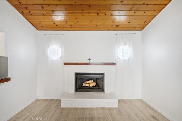 unfurnished living room featuring wood ceiling, light hardwood / wood-style floors, and plenty of natural light