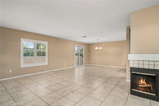 interior space with a fireplace, light tile patterned floors, and a notable chandelier