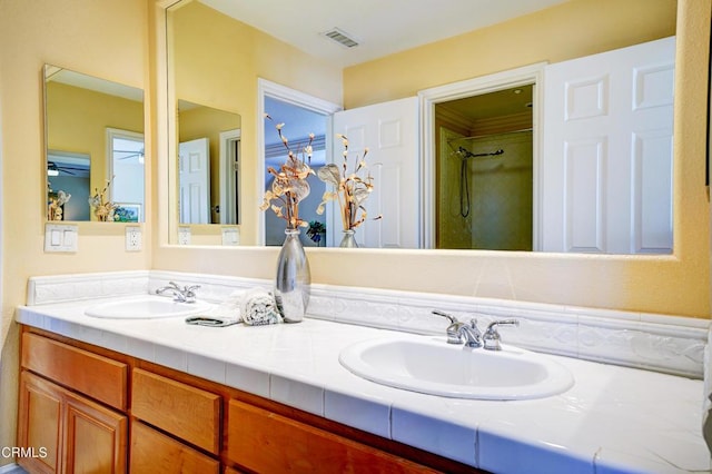 bathroom with ceiling fan and vanity