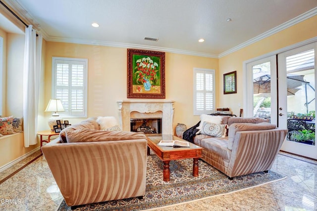 living room with a fireplace, french doors, and ornamental molding