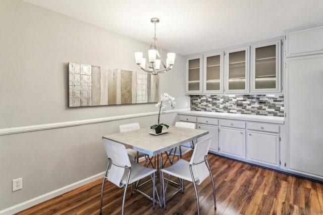 dining room with an inviting chandelier and dark hardwood / wood-style flooring