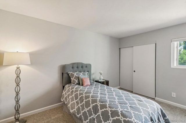 carpeted bedroom with a closet