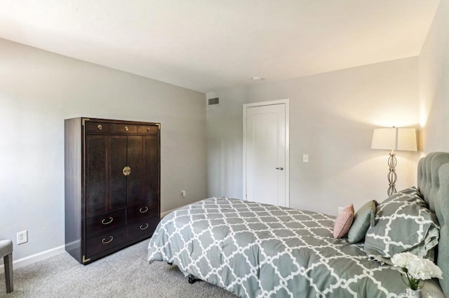 bedroom featuring light carpet