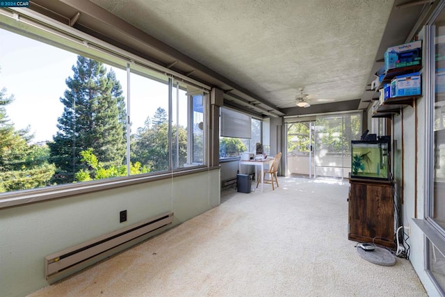 sunroom / solarium featuring ceiling fan and baseboard heating