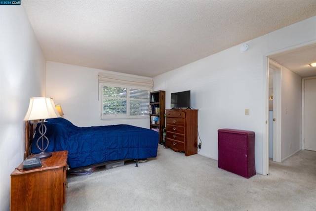 carpeted bedroom with a textured ceiling