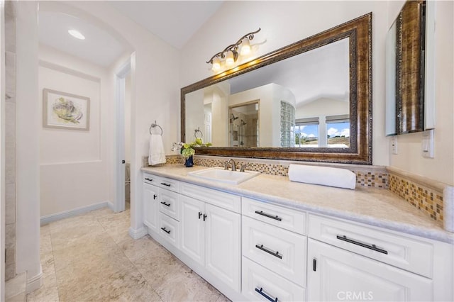 bathroom featuring vanity and vaulted ceiling