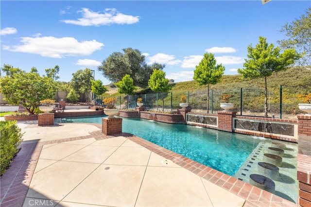 view of swimming pool with a patio area and pool water feature