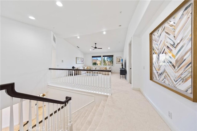 corridor featuring light colored carpet and vaulted ceiling