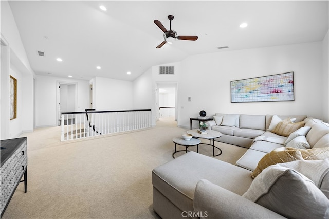 carpeted living room with ceiling fan and lofted ceiling