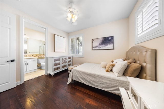 bedroom with dark hardwood / wood-style flooring, ensuite bathroom, and ceiling fan