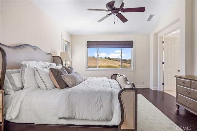 bedroom with ceiling fan, wood-type flooring, and lofted ceiling