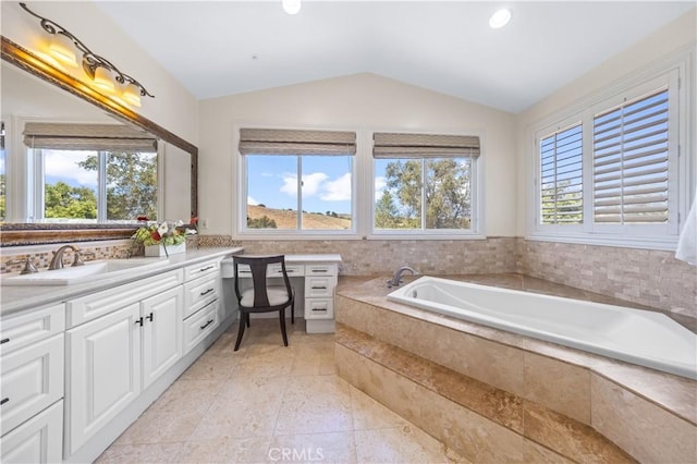 bathroom with a wealth of natural light, tile patterned flooring, vanity, and vaulted ceiling