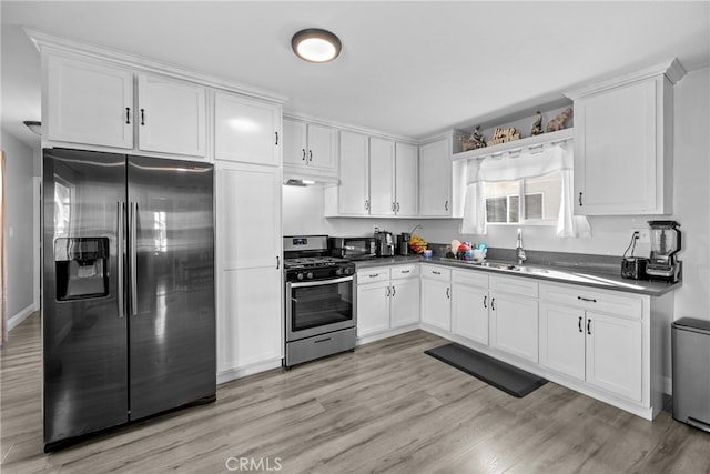 kitchen with premium range hood, stainless steel appliances, light hardwood / wood-style floors, and white cabinetry