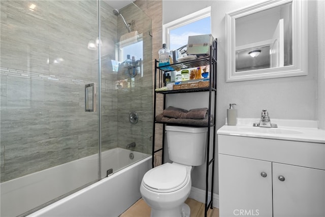 full bathroom with enclosed tub / shower combo, vanity, and toilet