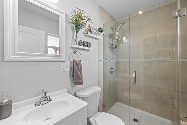 bathroom with a shower with door, toilet, and vanity