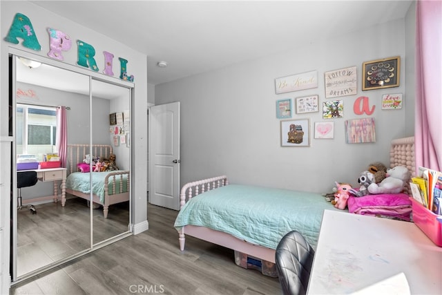 bedroom with a closet and hardwood / wood-style flooring