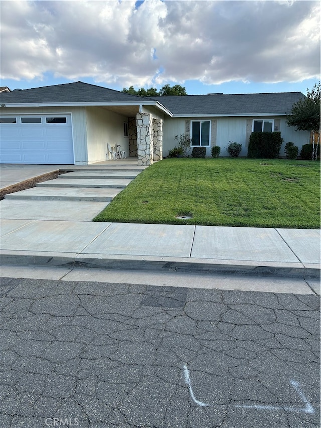 view of front of home featuring a garage and a front lawn