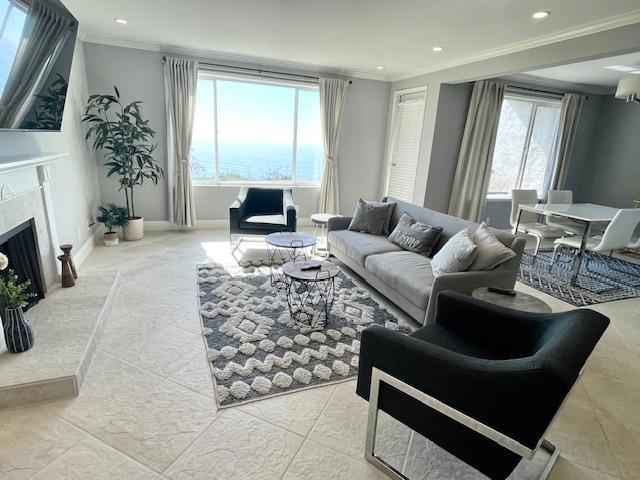 tiled living room featuring a premium fireplace and crown molding