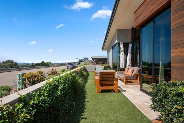 view of yard with outdoor lounge area and a balcony